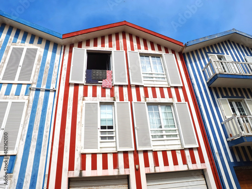 Colorful striped wooden beach houses at the promenade of Costa Nova, Aveiro, Portugal