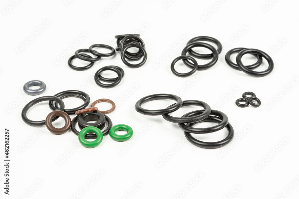 Hydraulic and pneumatic o-rings in different sizes and colors, on a white background. Various seals for plumbing. Sealing rings for hydraulic connections. Hydraulic and pneumatic o-rings in different sizes and colors, on a white background. Various seals for plumbing. Sealing rings for hydraulic connections.