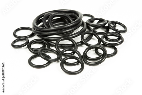 Hydraulic and pneumatic o-rings in black in different sizes on a white background. Various seals for plumbing. Sealing rings for hydraulic connections.