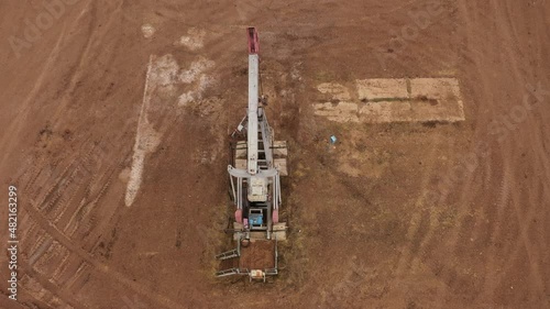 Pump jack in vast oil fields in Russia. Pipelines transporting oil from oil pumps, aerial drone shot