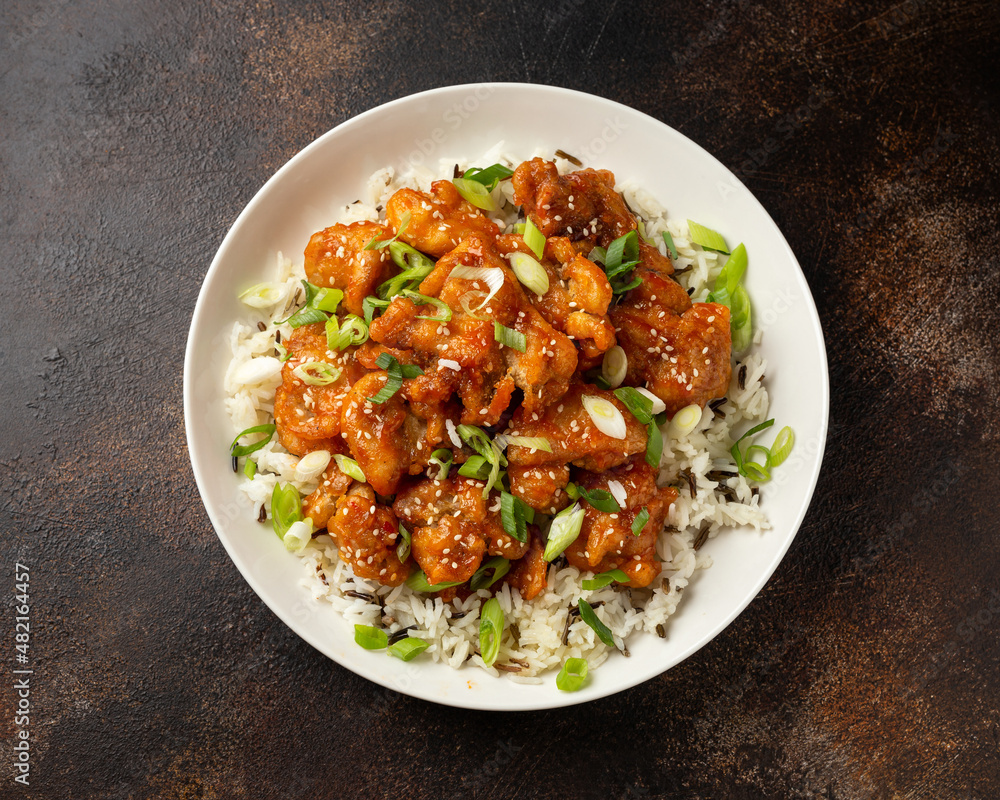 Asian crispy sweet sesame chicken with basmati, wild rice and spring onion. Asian crispy sweet sesame chicken with basmati, wild rice and spring onion.
