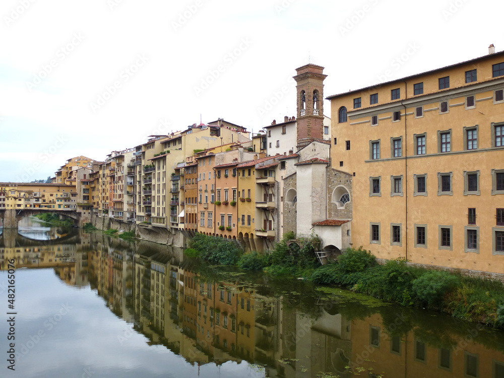 Charming waterfront buildings and Ponte Vecchio reflected in Arno river in Florence, Tuscany, Italy, Europe
