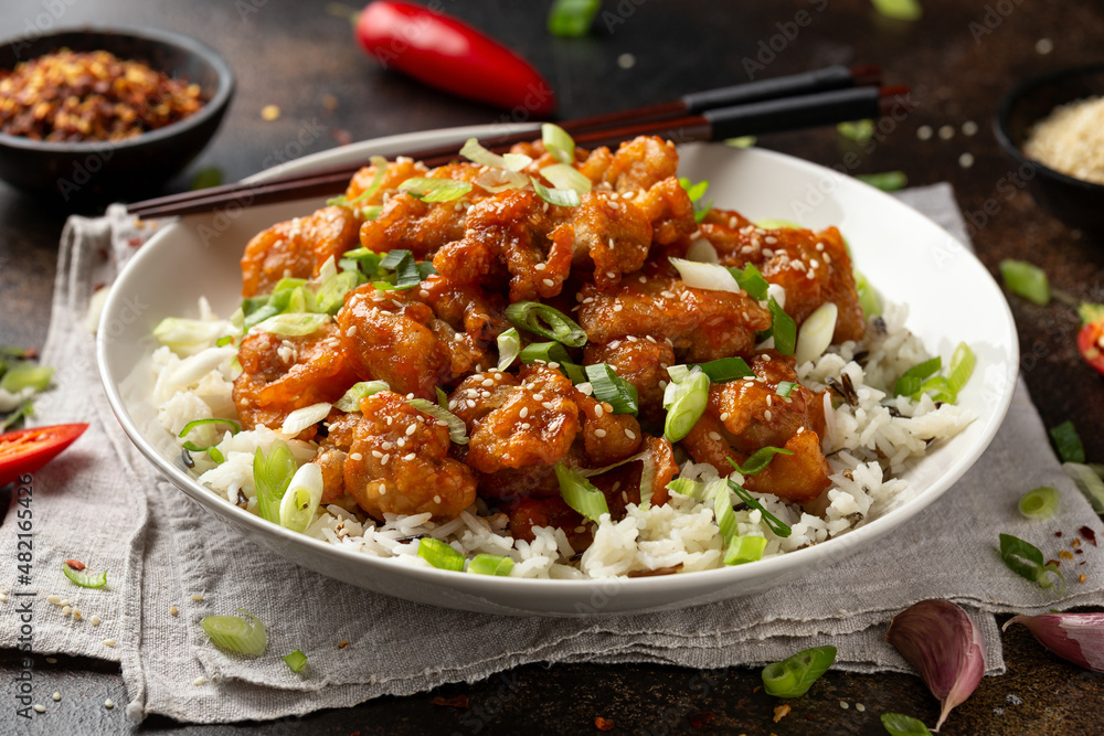 Asian crispy sweet sesame chicken with basmati, wild rice and spring onion. Asian crispy sweet sesame chicken with basmati, wild rice and spring onion.