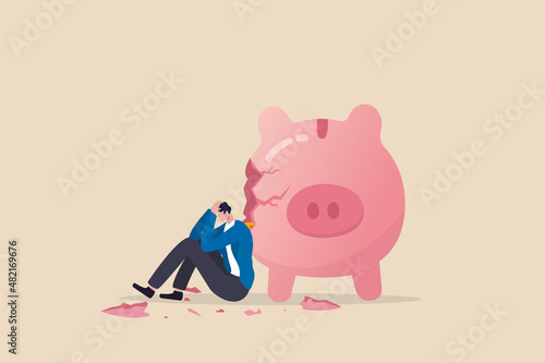 Debt and loan problem, financial mistake, poverty or bankruptcy concept, depressed businessman sitting with broken piggy bank. photo