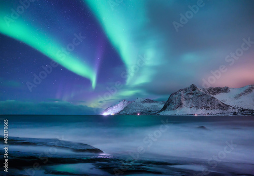Aurora borealis in Norway. Green northern lights. Night winter landscape with aurora. Natural background in Norway.