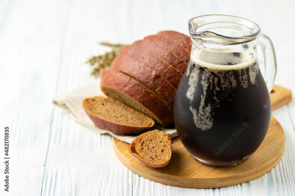 Refreshing fizzy summer drink, rye bread kvas on wooden background. Space for text. Refreshing fizzy summer drink, rye bread kvas on wooden background. Space for text.