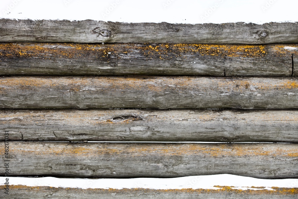 weathered surface of the old wooden log house wall close-up. log walls texture close up. Wooden Log cabin wall in snow close up. The frame of a wooden blockhouse. Vintage log wall surface full frame. weathered surface of the old wooden log house wall close-up. log walls texture close up. Wooden Log cabin wall in snow close up. The frame of a wooden blockhouse. Vintage log wall surface full frame.