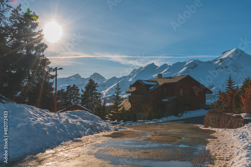 A picturesque landscape view of the snowcapped French Alps mountains and the ski resort buildings on a cold winter day (La Joue du Loup, Devoluy) photo