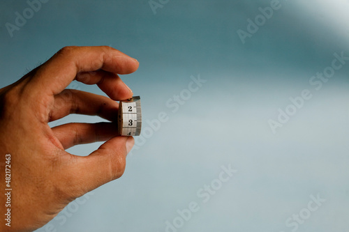 hand holding measuring tape
