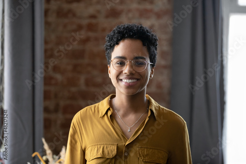 Happy millennial Afro American business lady head shot portrait. Young Black short haired professional woman, leader, entrepreneur profile picture. Smiling confident employee looking at camera