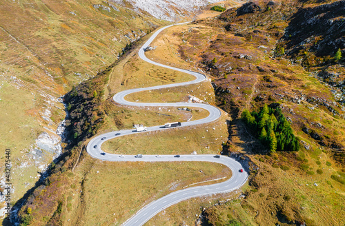 A road with turns through a mountain pass. Aerial landscape. An aerial summer...