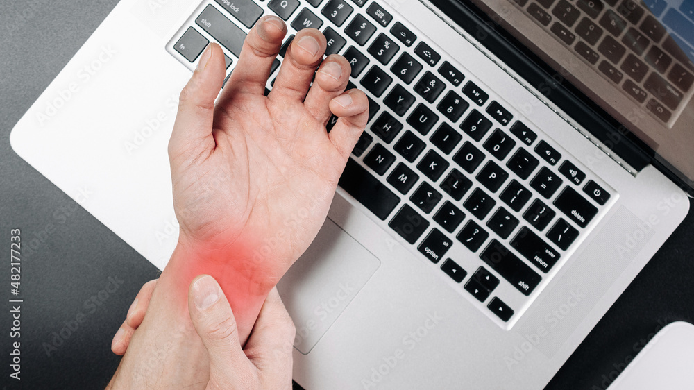 Arthritis hand. Arthritis office syndrome is consequence of computer. Hand pain in man injury