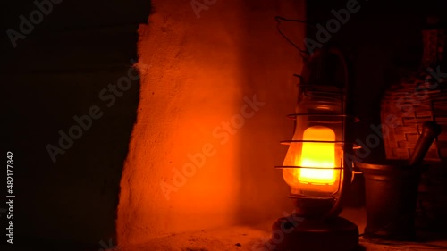 Close-up of a classic incandescent lamp. Glass bulb, inert gas and tungsten filament. Soft natural light. Lamp velvet effect. Is flaring up brighter and brighter.