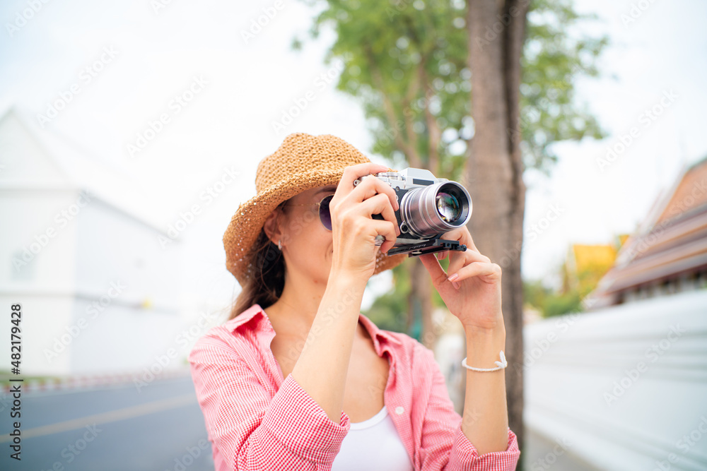 Beautiful tourist women take photo while travel on street of Bangkok city temple and city Beautiful tourist women take photo while travel on street of Bangkok city temple and city