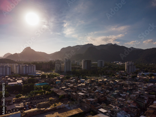 Aerial view of Jacarépagua in Rio de Janeiro, Brazil. Residential buildings and mountains in the background. Sunny day. Sunset. Drone photo photo