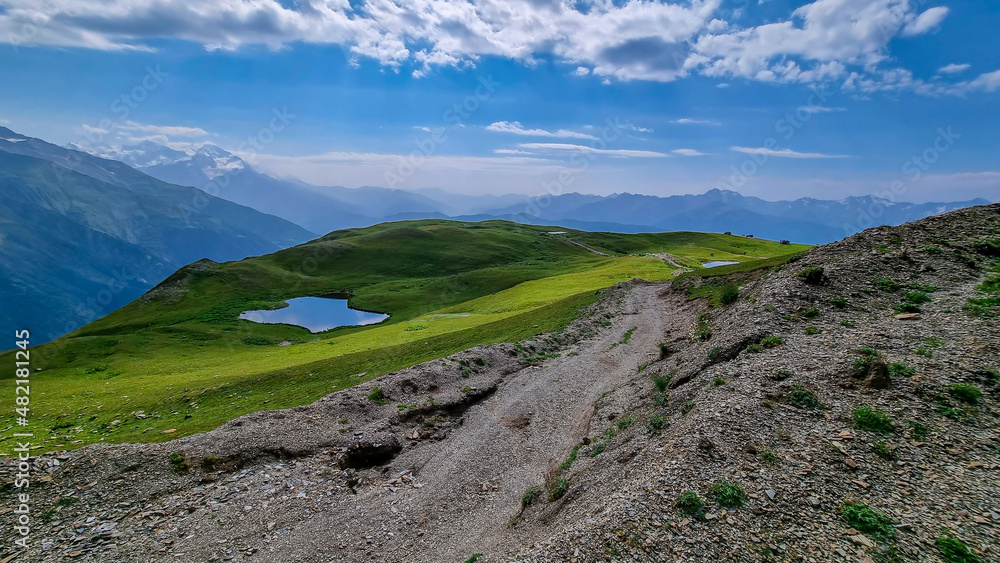 Koruldi Lakes with an amazing view on the mountain ridges near Mestia in the Greater Caucasus Mountain Range, Upper Svaneti, Country of Georgia. Reflection in the water. Alpine pasture. Wanderlust Koruldi Lakes with an amazing view on the mountain ridges near Mestia in the Greater Caucasus Mountain Range, Upper Svaneti, Country of Georgia. Reflection in the water. Alpine pasture. Wanderlust