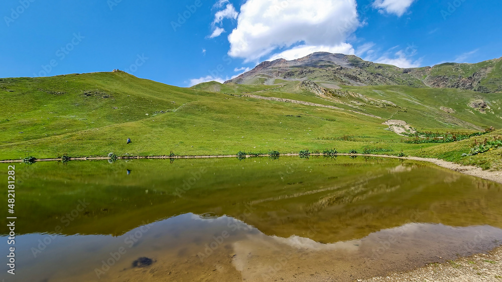 Koruldi Lakes with an amazing view on the mountain ridges near Mestia in the Greater Caucasus Mountain Range, Upper Svaneti, Country of Georgia. Reflection in the water. Alpine pasture. Wanderlust
