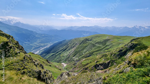 Dirt road leading to the Koruldi Lakes with an amazing view on the highlands and hills near Mestia in the Greater Caucasus Mountain Range, Upper Svaneti, Country of Georgia. Alpine pasture. Wanderlust