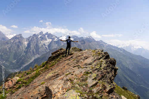 A male hiker enjoying the amazing views on the mountain ridges in the Greater Caucasus Mountain Range in Georgia, Samegrelo-Upper Svaneti Region. Freedom. Wanderlust. Trekking to Koruldi Lakes
