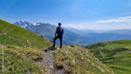 A male hiker enjoying the amazing views on the mountain ridges in the Greater Caucasus Mountain Range in Georgia, Samegrelo-Upper Svaneti Region. Freedom. Wanderlust. Trekking to Koruldi Lakes © Chris