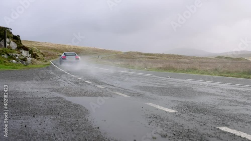 Audi R8 supercar hitting large puddle with big water splash in slow motion. photo