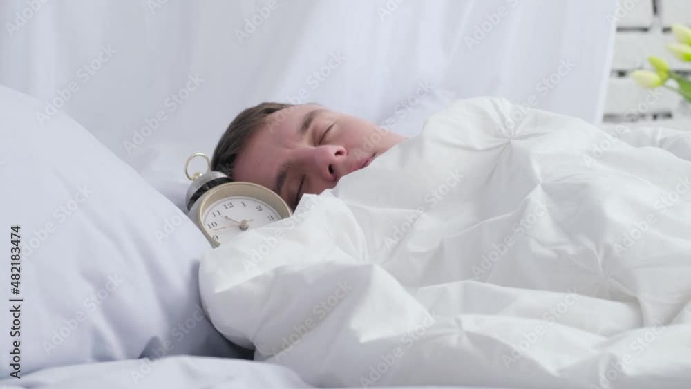 Overslept man sleeps sweetly in bed. Concept: healthy sleep, sleep disturbance, insomnia Overslept man sleeps sweetly in bed. Concept: healthy sleep, sleep disturbance, insomnia