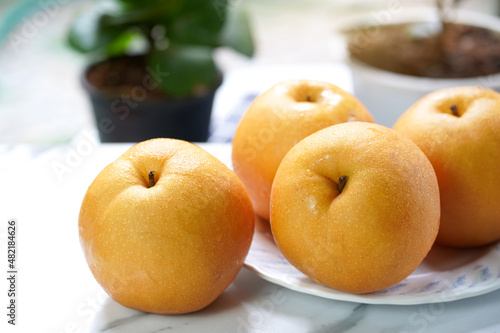 Snow pear or Fengsui pear on the  table in garden,Fresh Korea pear fruit. Korea pear fresh fruit on the plate.  photo