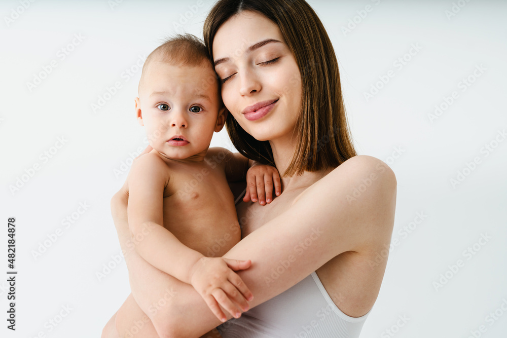 Beautiful woman holding baby boy, motherhood and pregnancy concept Beautiful woman holding baby boy, motherhood and pregnancy concept