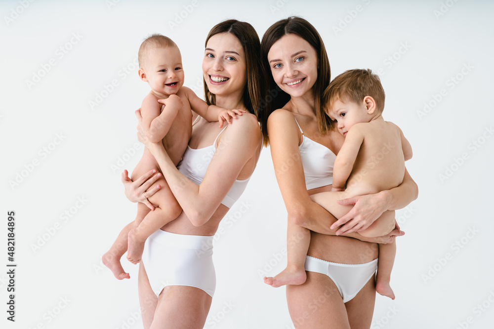 Beautiful women holding baby boys, motherhood and pregnancy concept