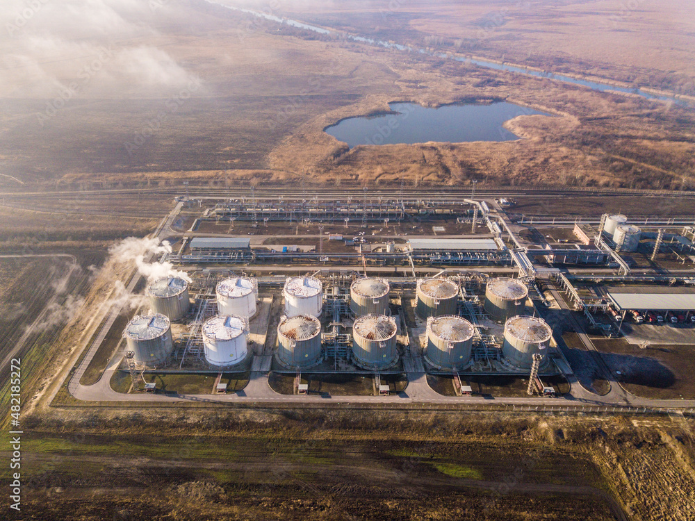 Aerial view of oil refinery and oil storage tanks. Shot from drone of ...