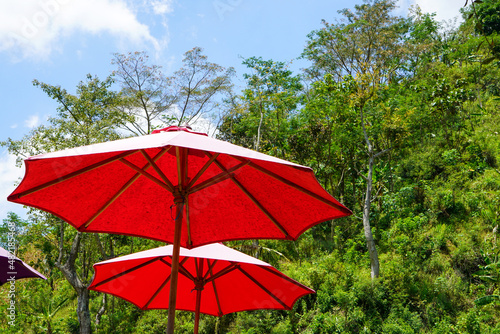 Colored umbrellas at an outdoor cafe in the tourist area of ​​​​the muria mountains, Central Java, Indonesia.