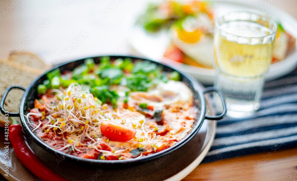 Egg shakshouka dish on a restaurant table Egg shakshouka dish on a restaurant table
