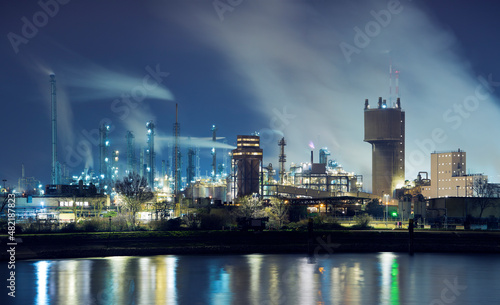 Petrochemical industry factory by a river at night