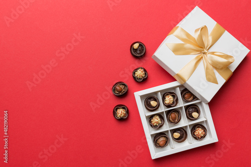 White box with chocolates candies and golden tape. top view with copy space