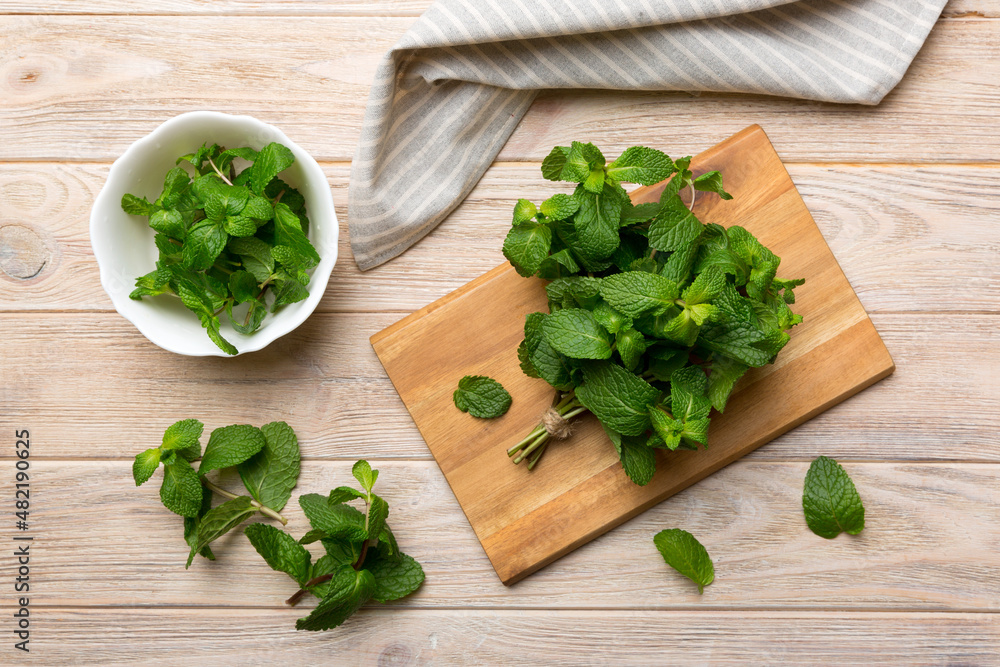 Fresh mint on Cutting board table, top view. Flat lay Space for text Fresh mint on Cutting board table, top view. Flat lay Space for text