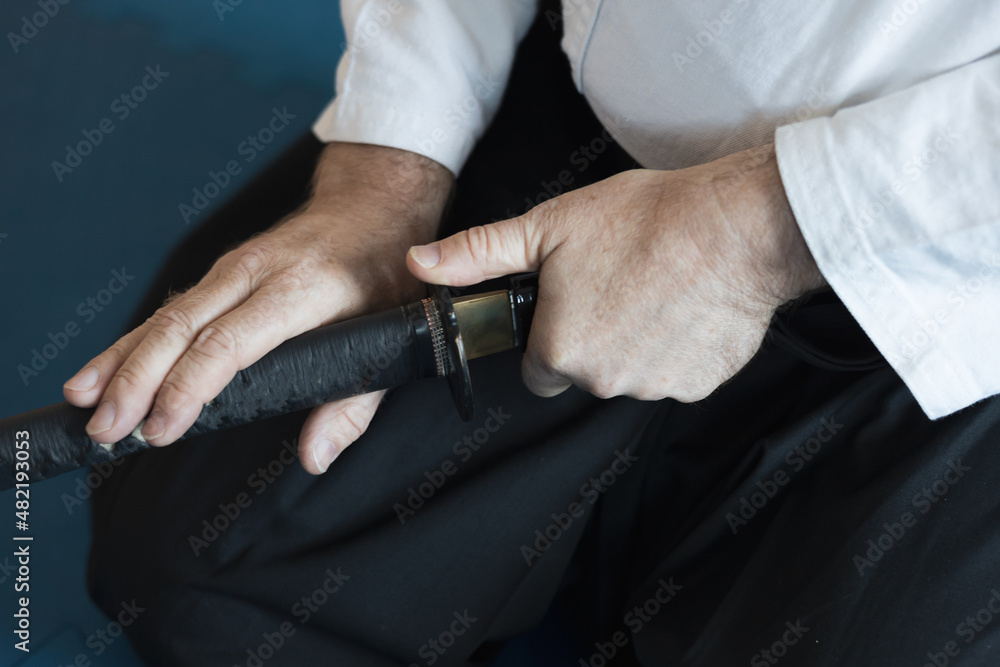 a warrior in a white kimono takes out a sword from its scabbard a warrior in a white kimono takes out a sword from its scabbard