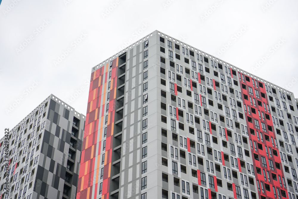 Fototapeta premium High-rise hotel or apartment buildings are a residential solution for people who live and work in big cities that are very densely populated and land is very expensive.
