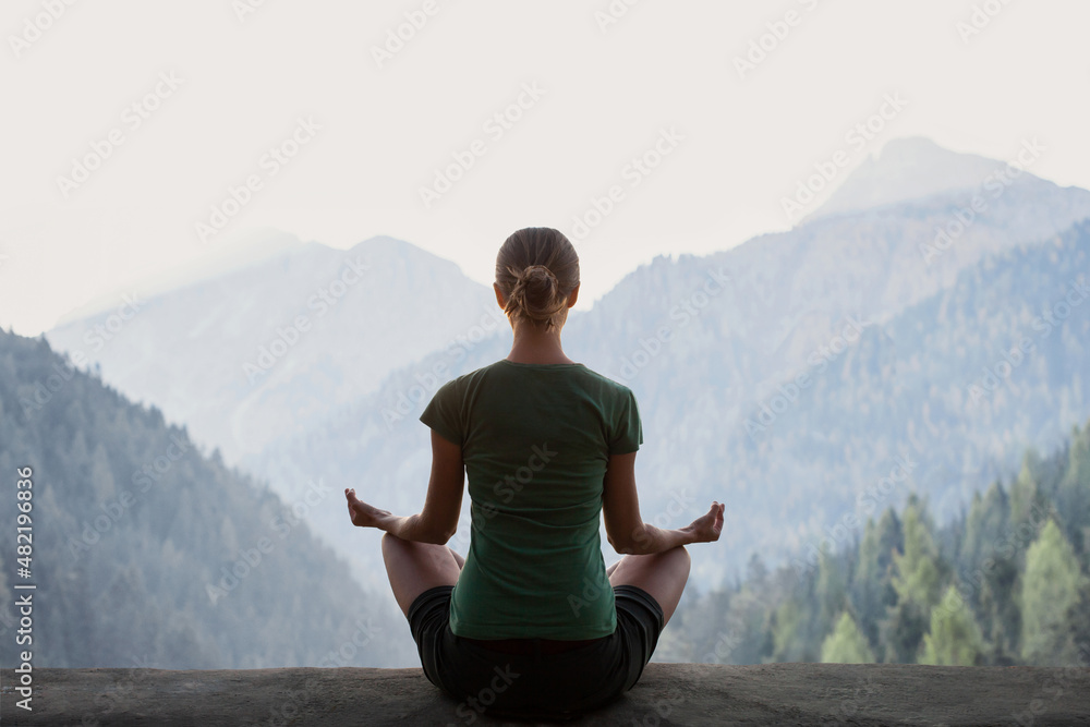 Young woman practicing yoga in mountains at sunset. Harmony, meditation, healthy lifestyle, relaxation, yoga, self care, mindfulness concept - obrazy, fototapety, plakaty 