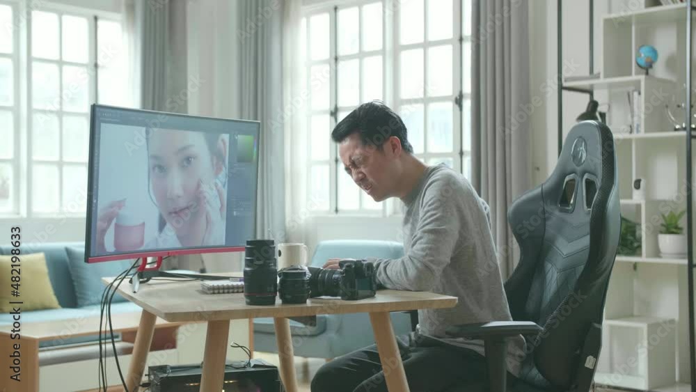 Asian Cameraman In Long Sleeved T-Shirt And Black Pants Having Backache While Using Desktop Computer For Editing Photo At Home.
Asian Cameraman In Long Sleeved T-Shirt And Black Pants Having Backache While Using Desktop Computer For Editing Photo At Home.
