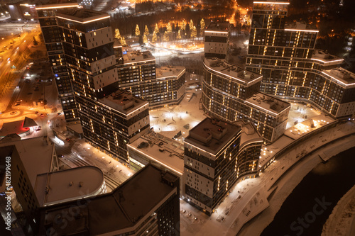 night panorama of residential area with high-rise buildings with road and motor transport, modern illumination of buildings. Futuristic style. Yekaterinburg, Russia