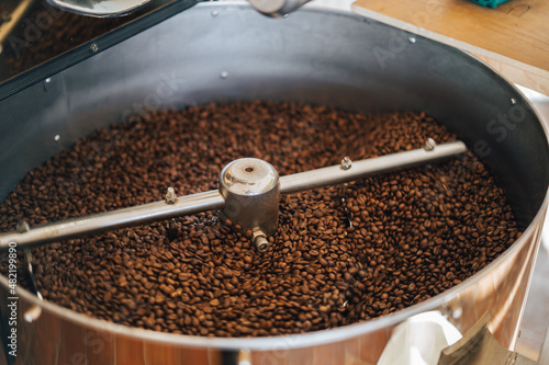 The process of roasting coffee beans. Coffee beans being roasted in a roasting machine. 