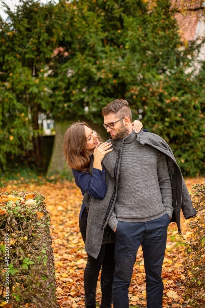 Fototapeta premium Tender young european married couple in park in autumn