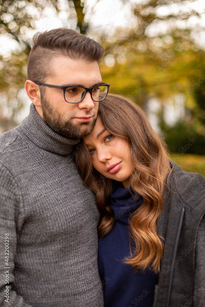 Serious young european married couple portrait in fall Serious young european married couple portrait in fall