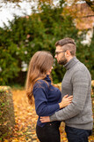 Tender young european married couple in park in fall
