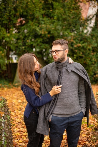 Caring young european married couple in autumn park