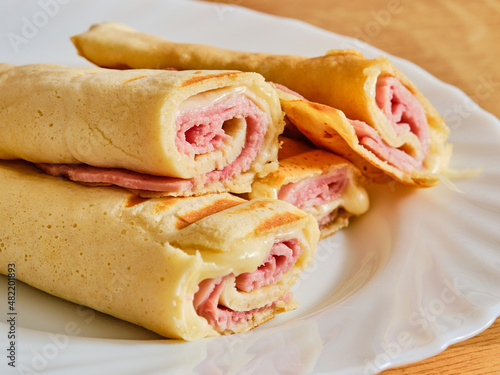 Pancakes with ham and cheese on plate