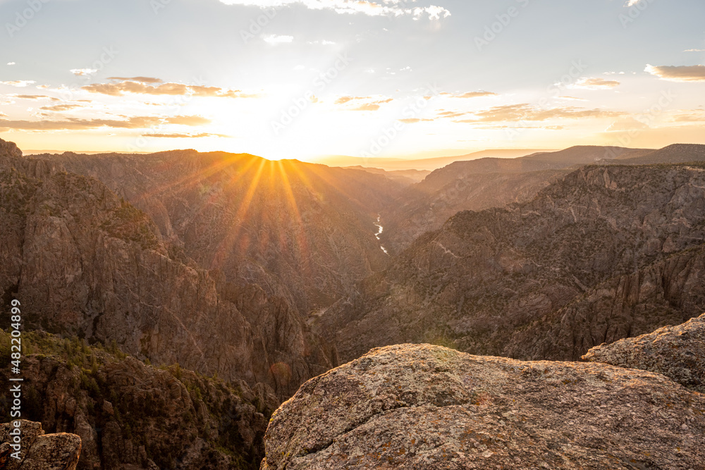 Obraz premium Warm Orange Light At Sunset Over Black Canyon