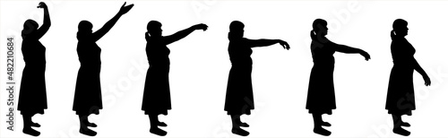 Dance teacher in a skirt, blouse. Hands in motion, legs without movement, standing still. Smooth, elegant, graceful hand movements. A group of women stands straight and moves their arms. Side view.