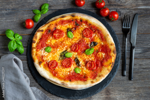 pizza with tomatoes, mozzarella cheese and basil