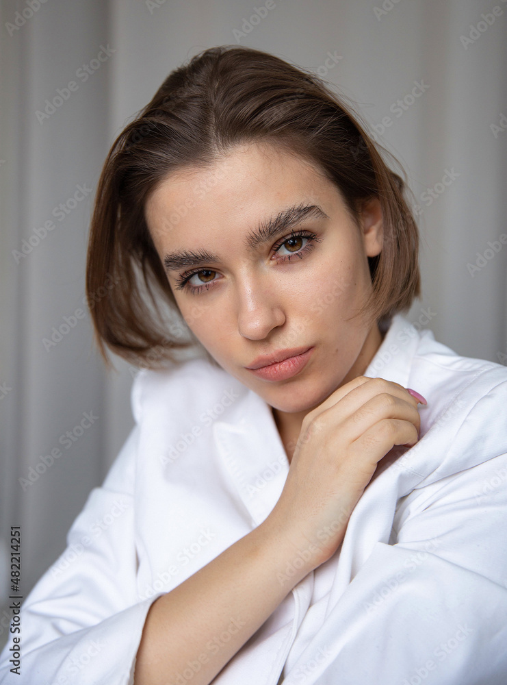 Portrait of white european woman with bob cut and hand near her face Portrait of white european woman with bob cut and hand near her face